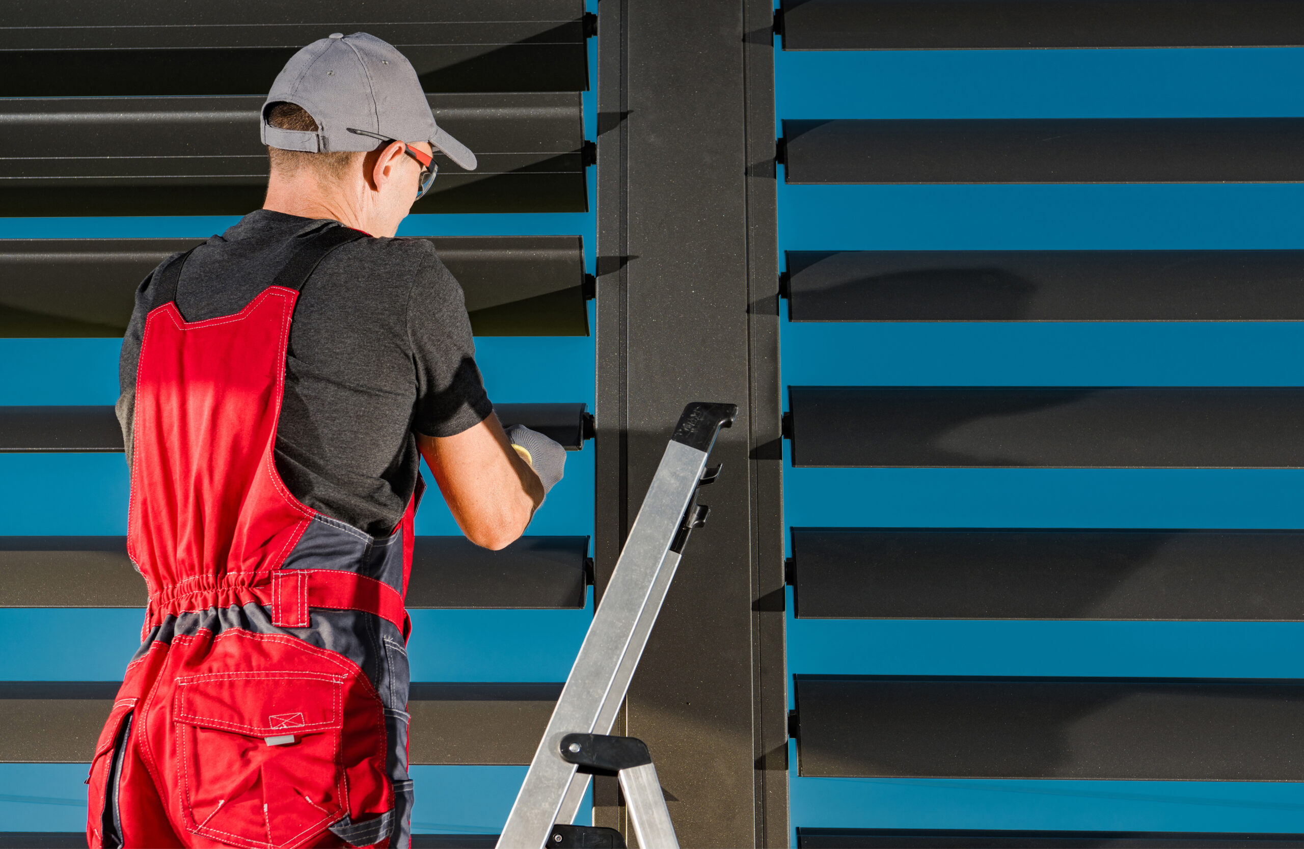 Worker Finishing Installation of Modern Pergola Wall Shade Shutt